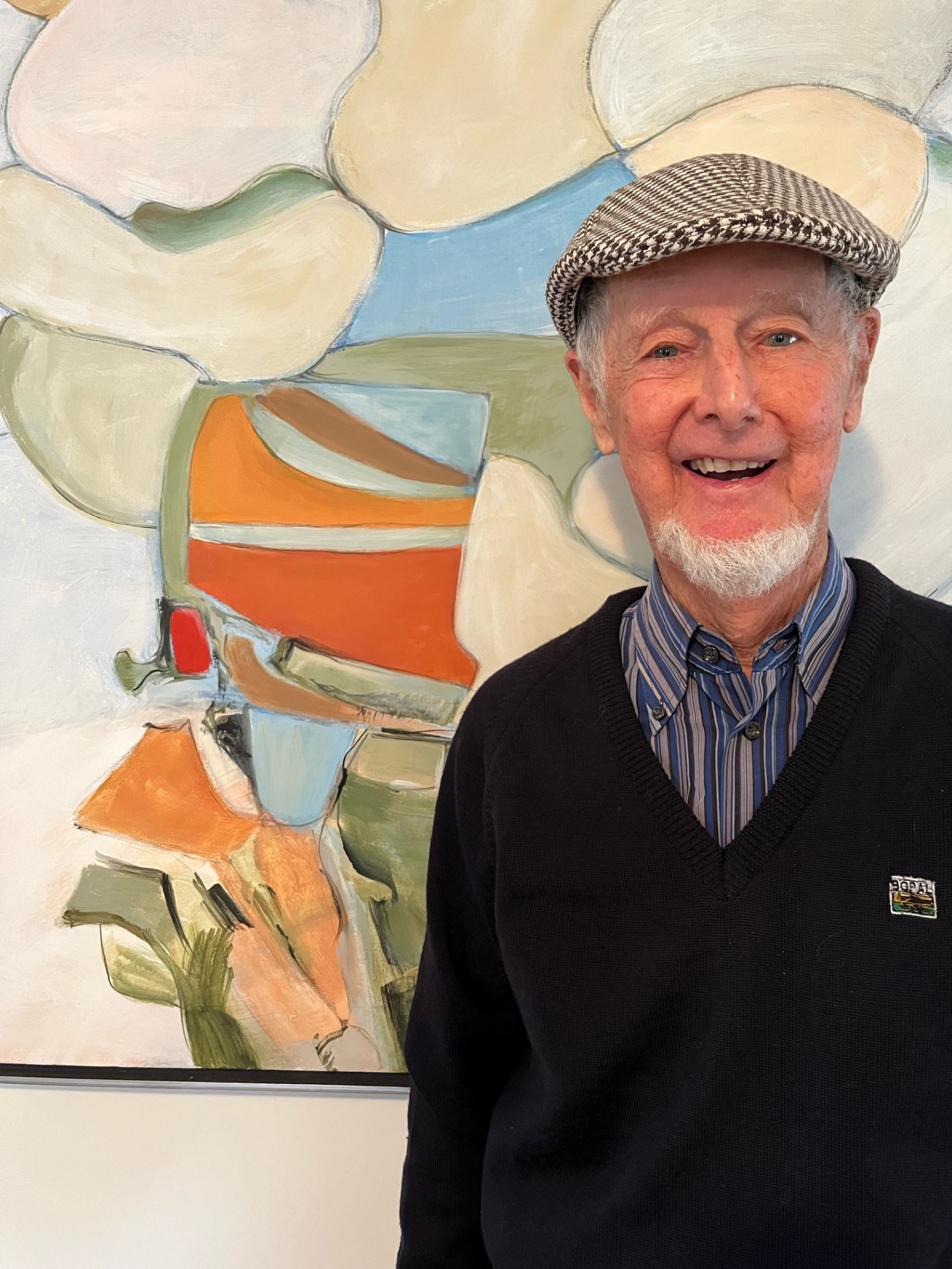Portrait of Brian Hatch in front of abstract painting in his studio